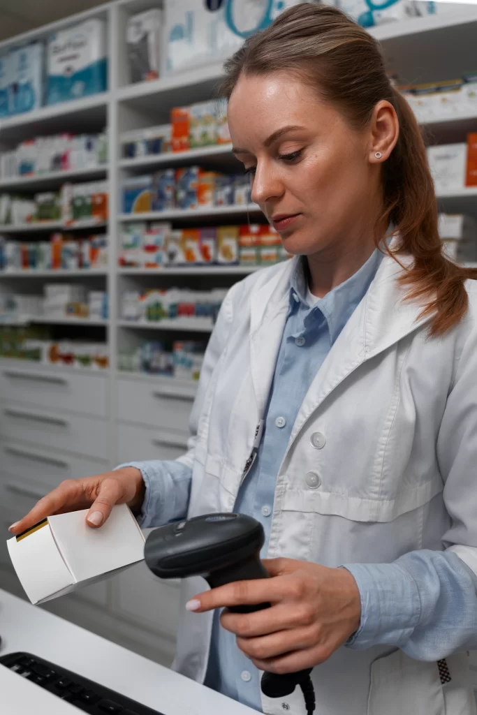 female pharmacist scanning medicine counter